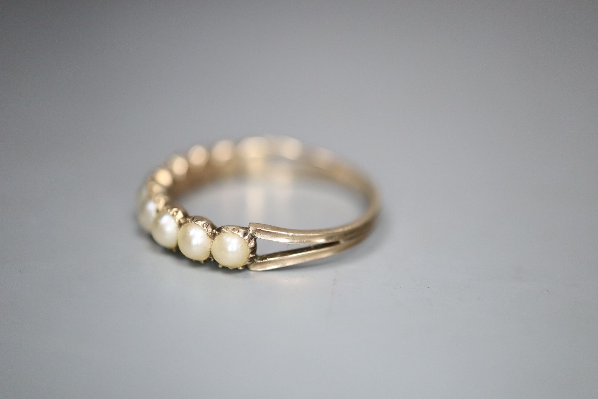 A 19th century gold and split pearl half hoop ring, set with ten pearls, gross 1.6 grams, size O/P.